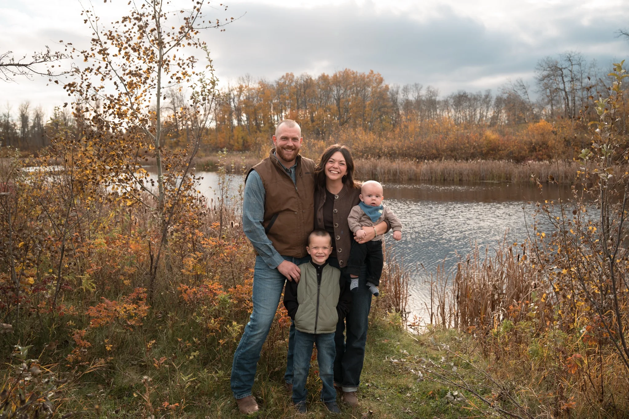 Scott and Kathy Van Dijk with their two sons outdoors in Central Alberta